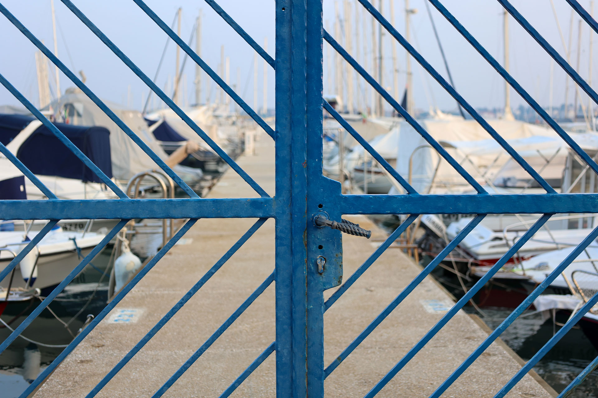 Boats in a harbour behind a locked gate