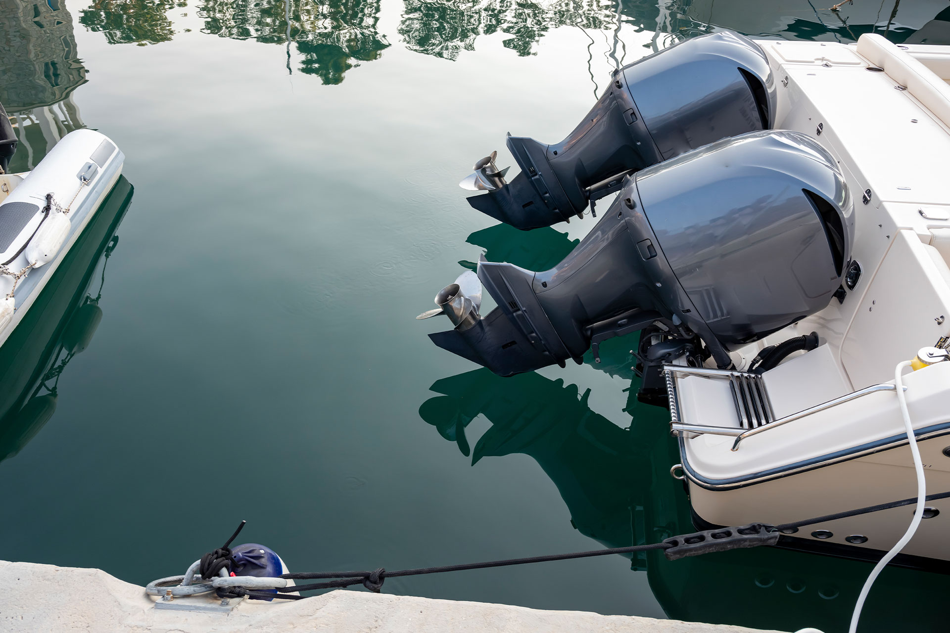 A boat with two outboard motors in a harbour